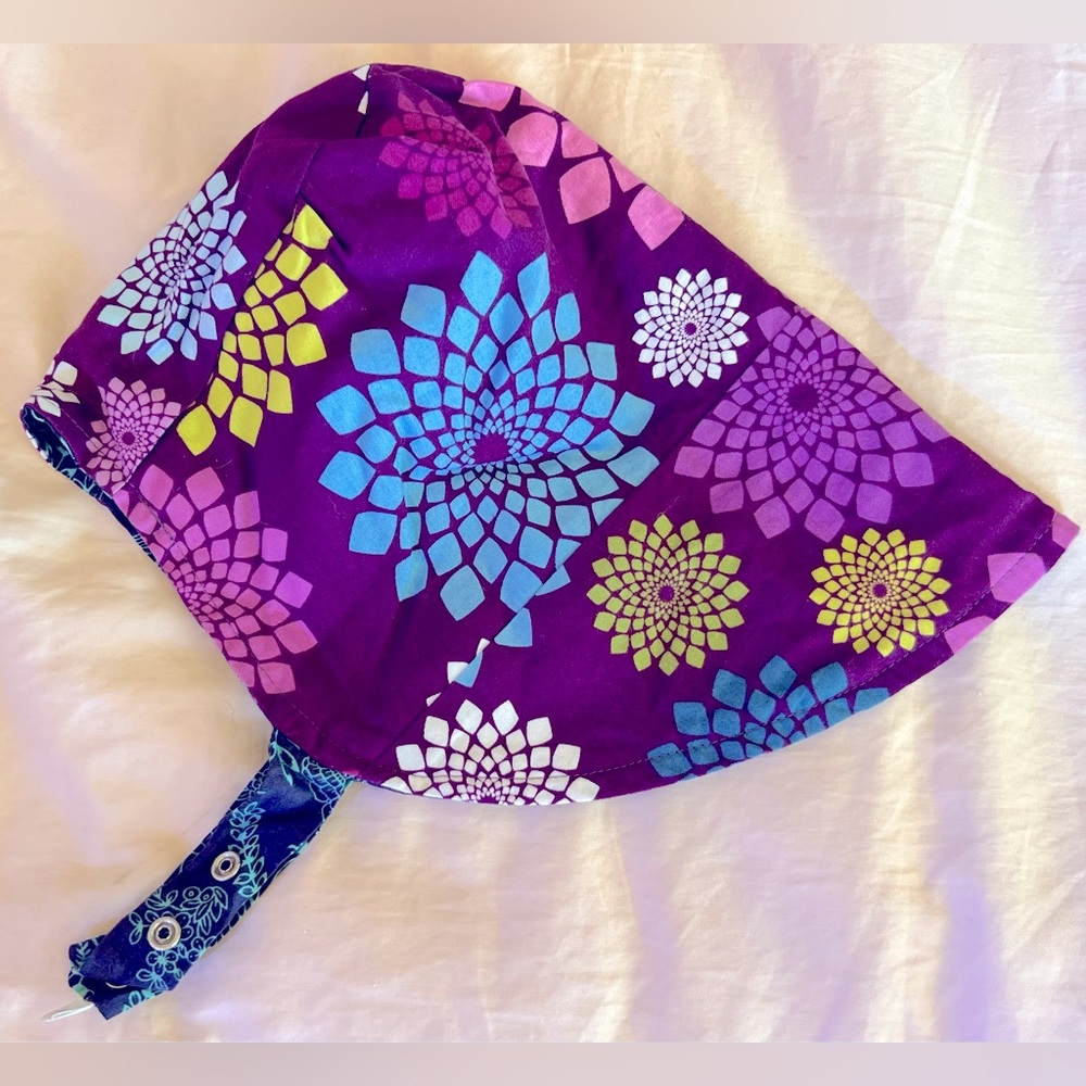 Reversible patterned sun bonnet. Like new-barely worn. Adjustable snap closure.